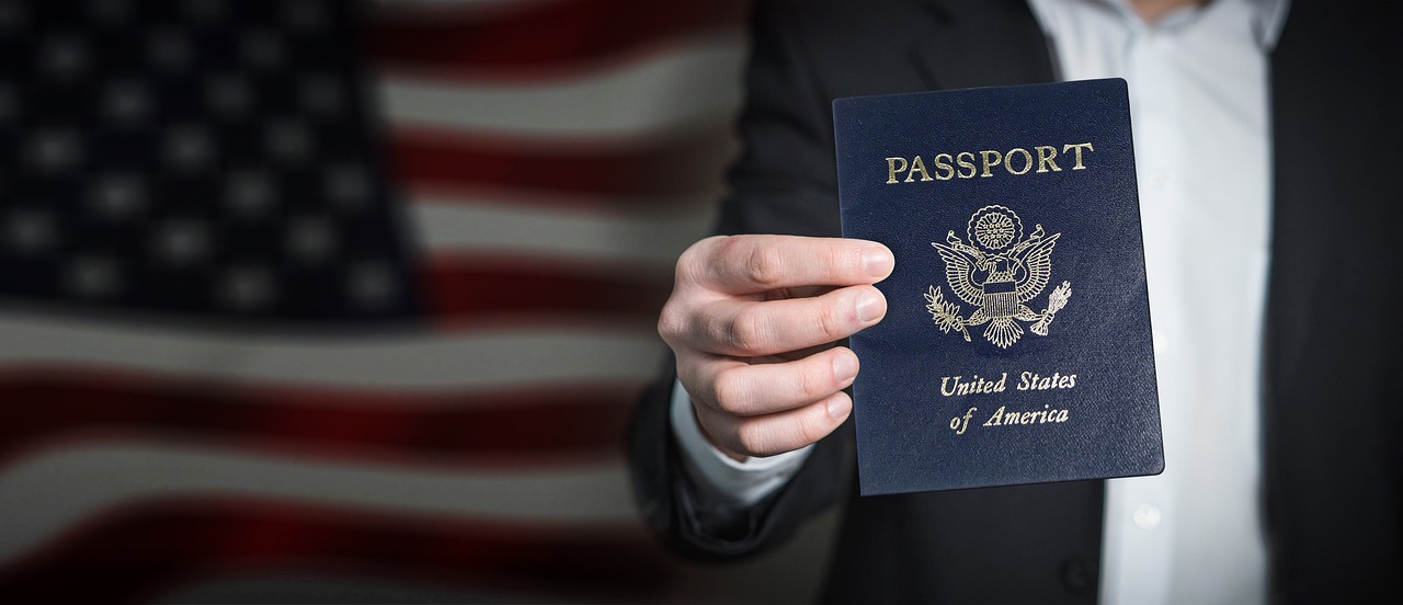 man checking visa documents at desk