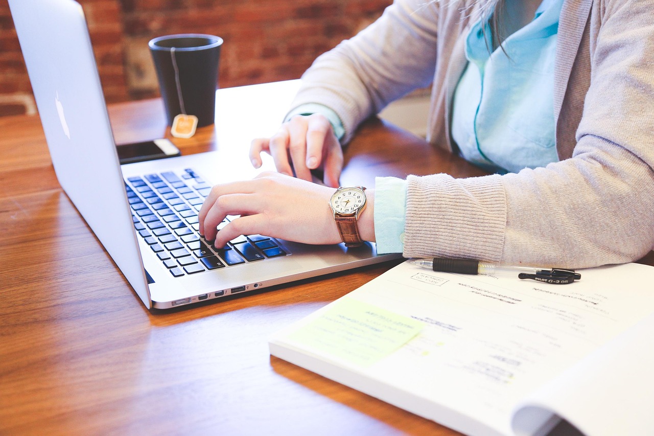 typing passport number on laptop keyboard